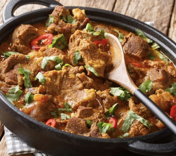 Lamb curry garnished with herbs